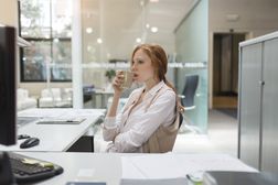 Business woman looking at computer screen.