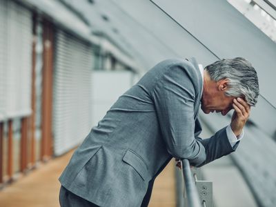 Desperate businessman leaning on railing