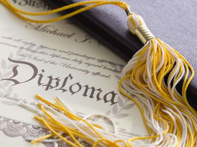Close-up view of graduation tassel and diploma for sales and marketing