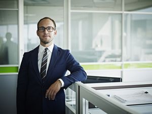young businessman by cubicle