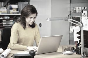 在计算机上写辞职信的女人“class=