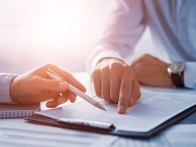 Two men reviewing a legal writing sample.