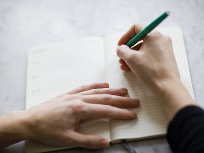 Woman writing on diary