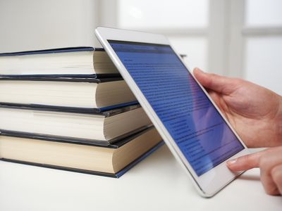 ereader against stack of books