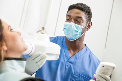 Young dentist/dental assistant at work