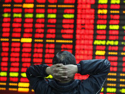 Man watching stock market monitor