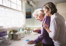 Daughter and Elderly mother checking medicine