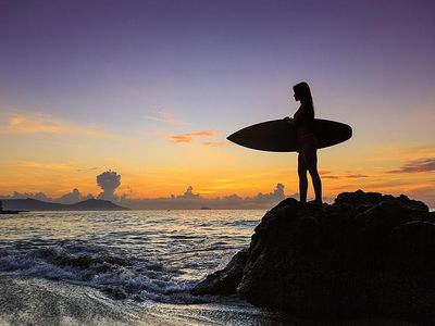 海滩上冲浪的年轻女人