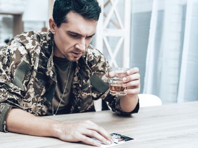 soldier in fatigues holding a drink
