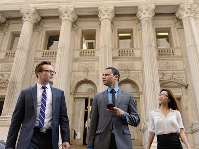 Business people in front of New York State Courthouse