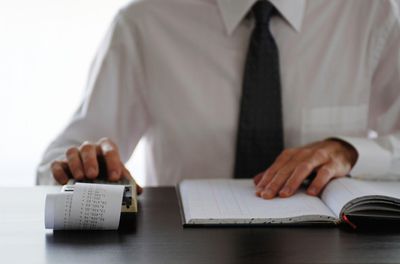 a businessman working on a ten key