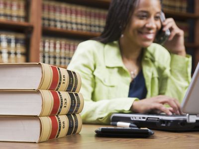 Woman sitting at desk in front of legal books