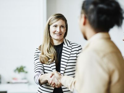 Two businesswomen shaking hands.