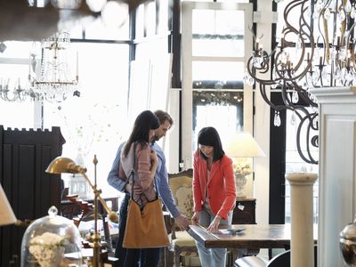 Female sales associate helping customers in furniture store