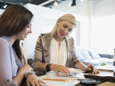 Woman working part-time as an interior designer talking to customer in a furniture store.