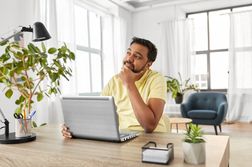 Man with laptop working at home office