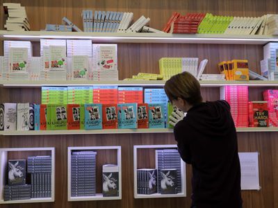 Employee arranging a book display at the Frankfurt Book Fair.