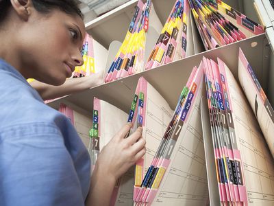 Nurse sorting medical files in hospital