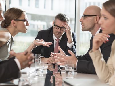 Group of five businessmen in disagreement