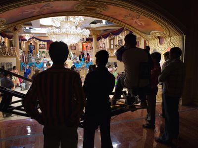 Film crew in silhouette in front of Bollywood film set