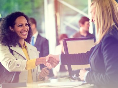 Banker shaking hands with a happy customer