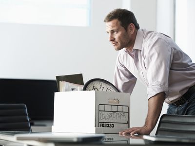 Businessman packing up box in office