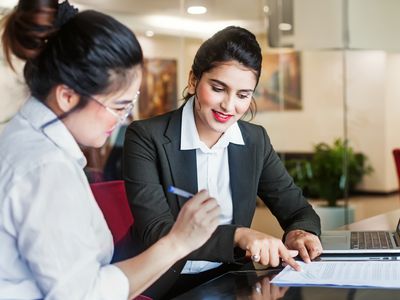 Saleswoman and client signing a contract