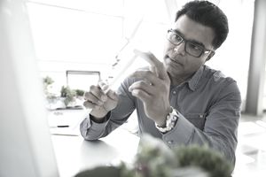 Engineer examining wind turbine model in laboratory