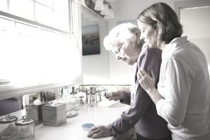 Daughter and Elderly mother checking medicine
