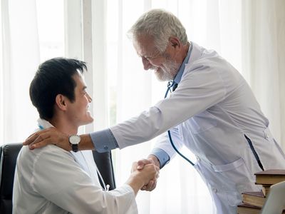 Young doctor talking with professor