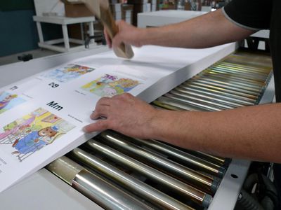 A worker working on a book in the production process