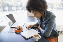 Focused woman working at digital tablet