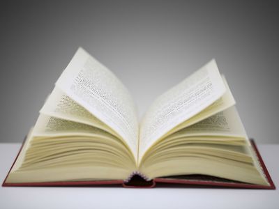Close up of open book on counter