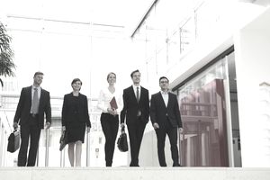 Business professionals walking in office building