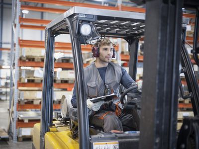 Technician at work in sheet metal component factory
