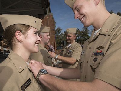 Man putting pin on woman in the navy