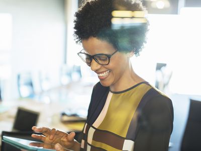Happy woman looking at tablet