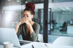 Worker stressed out in front of laptop at the office