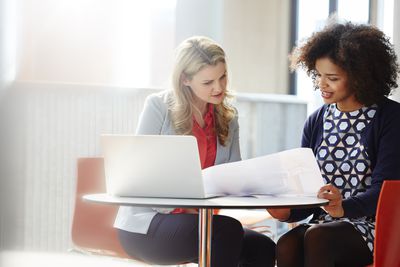 Two businesswomen using their communication skills to discuss plans.