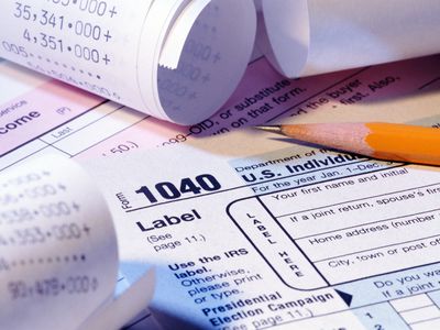 tax papers with adding machine tapes and pencil