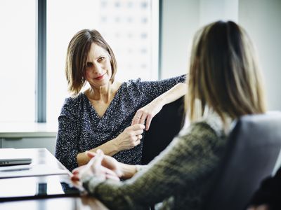 Mature businesswoman in discussion with colleague