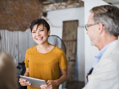 a business woman conversing with co-workers