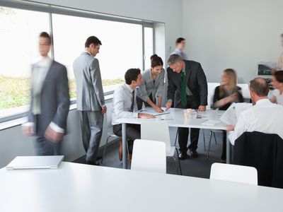 a group of business people conversing in a training area