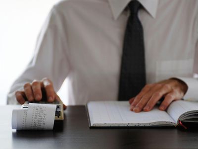 a businessman working on a ten key