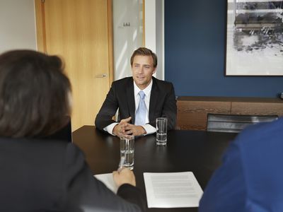 man interviewing with resume on table