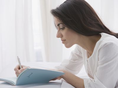 A woman writing in her journal