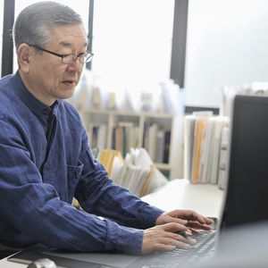 Senior man working on a computer in the office
