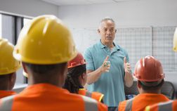 Man discussing safety with construction workers