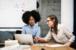Two young women having a discussion in a business