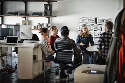 Businesswoman leading meeting in startup office